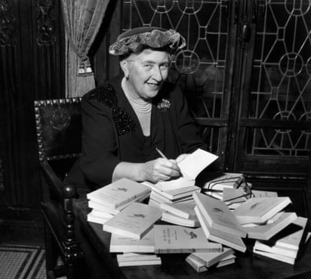 British mystery author Agatha Christie (1890-1976) autographing French editions of her books, circa 1950.