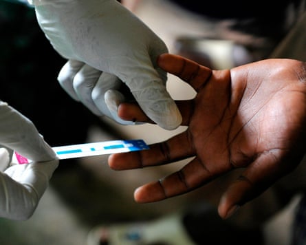 Acommunity health worker screening a patient in Ndiwa, Homa Bay County.