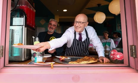 SNP leader and Scottish first minister John Swinney visits a pizza restaurant as he campaigns in Edinburgh .