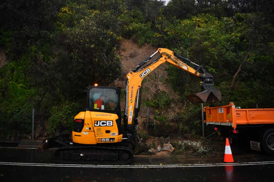 A landslide closes a lane of Lawrence Hargrave Drive at Seacliff Bridge in Coalcliff, south of Sydney, Thursday April 7, 2022. A flood warning has been issued for several saturated river basins across NSW, with heavy rain and thunderstorms forecast for the future days .