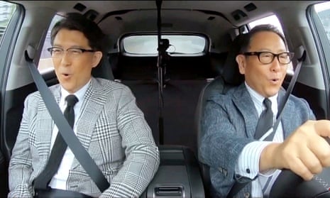 Two men in the front seats of a car