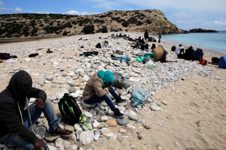 People rest on Tripiti beach on Gavdos after disembarking a fishing boat