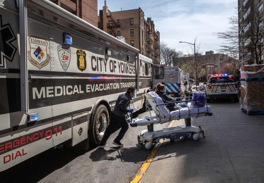 A worker wearing personal protective equipment (PPE), pushes a COVID-19 patient from a specialized bus known as a Medical Evacuation Transport Unit (METU), which carried patients to the Montefiore Medical Center Moses Campus on April 07, 2020 in the Bronx borough of New York City.