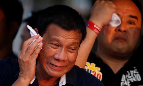 Rodrigo Duterte wipes perspiration off his face during campaigning in Malabon, Manila.