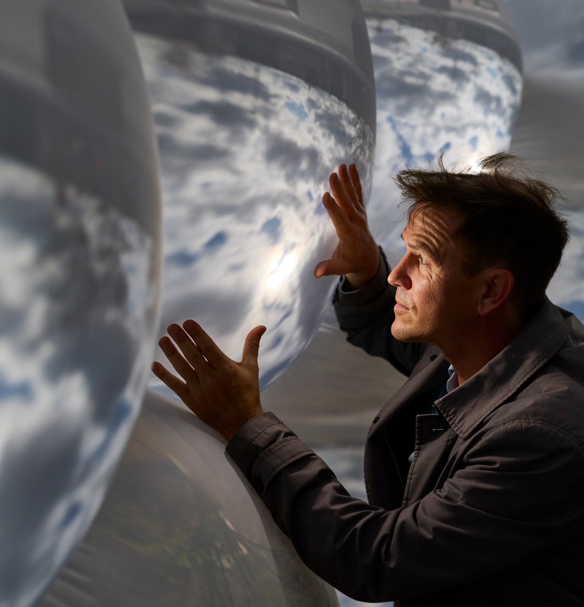 Luke Jerram inside his Pollenarium, touching the inside of one of the lenses.