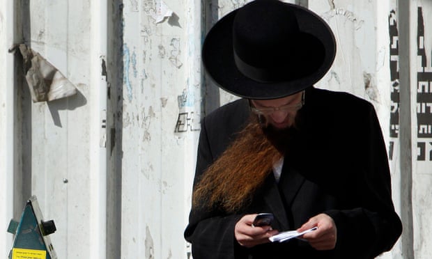 An ultra-Orthodox Jewish man uses his phone in Bnei Brak, near Tel Aviv.