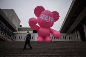 Seoul, South Korea. A pedestrian passes an inflatable bear outside Sejong theatre