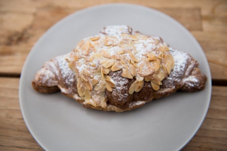 A flaky almond croissant on a plate