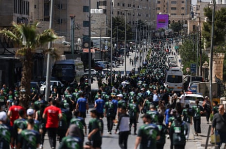Hundreds of runners fill a street in Bethlehem for the Palestine Marathon.