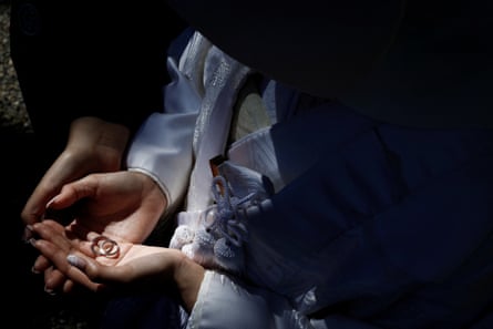 A bisexual couple pose with rings for wedding photos in a traditional garden in Yokohama