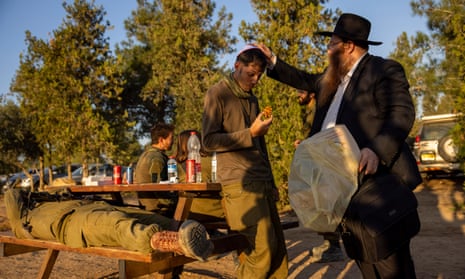 A rabbi brings sweets to Israeli solders in southern Israel