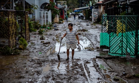 A man shovels mud in the aftermath of Typhoon Goni in Batangas, south of Manila, Philippines