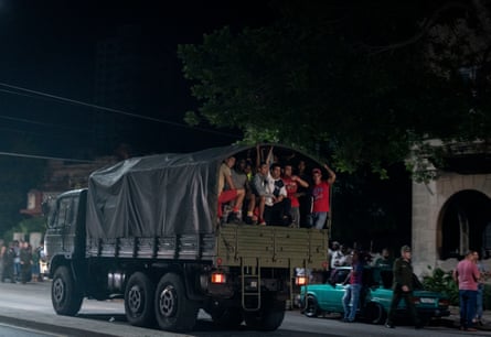 Plainclothed security personnel patrol Havana during protests against power outages, 2022.