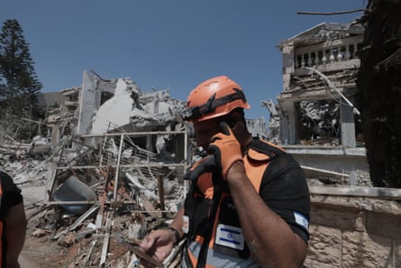 An emergency worker in suburb of Tel Aviv after with crumbling buildings