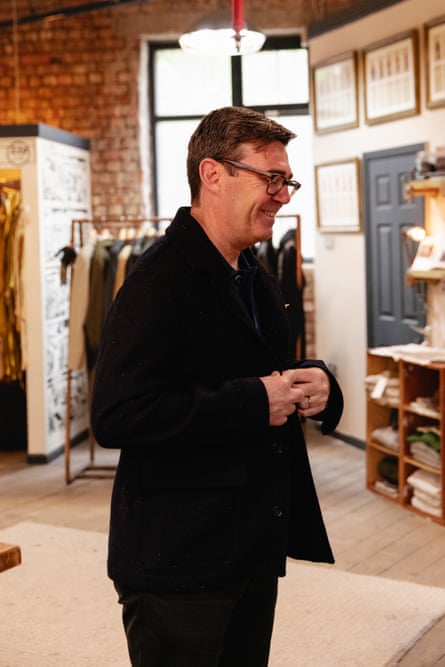 A smiling Andy Burnham tries on a black Private White VC jacket