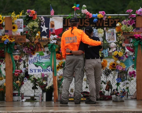 Members of a search and rescue team visit a memorial wall for flood victims on 13 July in Kerrville, Texas.