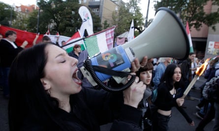 a woman shouts into a megaphone