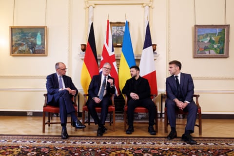 Friedrich Merz, Keir Starmer, Volodymyr Zelenskyy and Emmanuel Macron sit behind a row of flags in 10 Downing Street