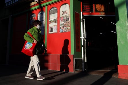 A woman wearing a face mask walks through the Chinatown section of San Francisco, California, U.S., February 26, 2020.