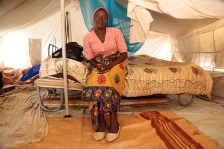 Chipo Ruwo sits on a bed in her tent in a makeshift camp in Chimanimani, Zimbabwe
