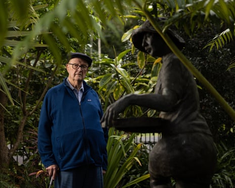 William Robinson in 2022, near the statue of his late wife Shirley in his garden.