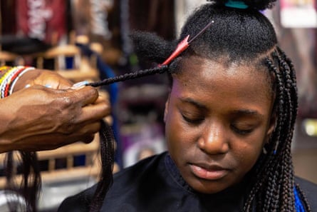 a women getting her hair braided
