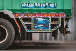 A flap next to a truck’s back wheel, painted to resemble a tranquil lagoon