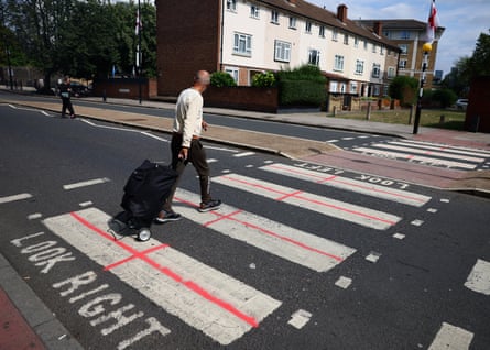 A pedestrian crossing with St George’s crosses drawn on the white rectangle bits