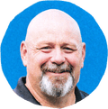 man smiling against blue background