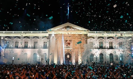 El Salvador President Nayib Bukele, accompanied by his wife Gabriela Rodriguez, addresses supporters from the balcony of the presidential palace in San Salvador, El Salvador, after polls closed on 4 February.