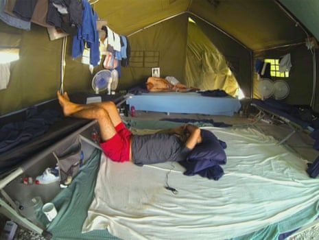 Asylum seekers lie in tents in the detention centre on Nauru: