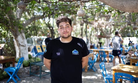 Giorgos Anastassas standing in front of his badly damaged Panorama restaurant