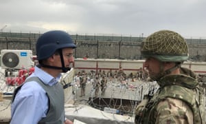 Laurie Bristow speaks with an HMG staff member as they facilitate the UK evacuation effort in Kabul, Afghanistan.