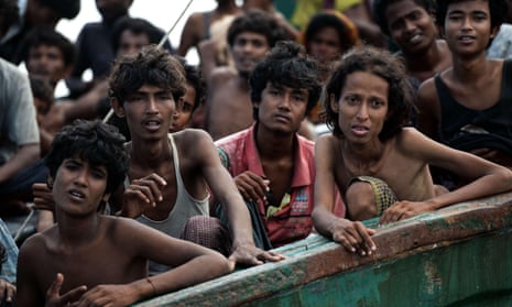 Rohingya migrants sit on a boat drifting in Thai waters off the southern island of Koh Lipe