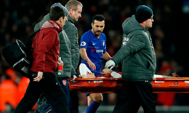 Hector Bellerín is consoled by his compatriot, Chelsea’s Pedro, after injuring his knee in Saturday’s match at the Emirates.