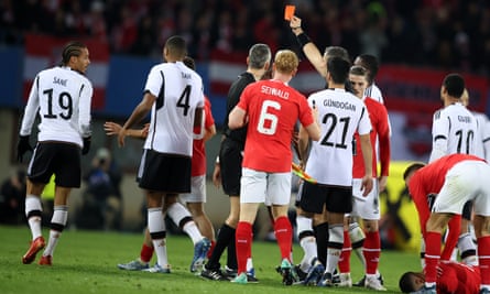 The referee shows a red card to Leroy Sané after he clashes with Phillipp Mwene during the international friendly match between Austria and Germany at Ernst Happel Stadion