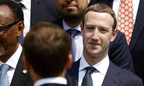 Mark Zuckerberg listens to the French president, Emmanuel Macron, at the Élysée Palace in Paris