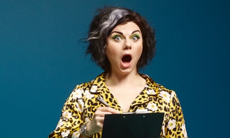 Caitlin Moran holding a clipboard and looking shocked