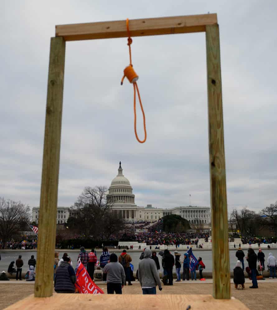 A noose hanging from a makeshift gallows with the US Capitol building seen in the background.