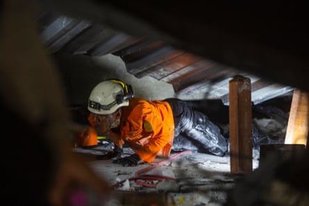 A rescuer searches for survivors of a collapsed building at an Islamic boarding school in Sidoarjo, East Java, Indonesia, 30 September 2025.