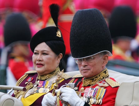 King Bhumibol Adulyadej and Queen Sirikit after reviewing an honour guard in Bangkok, 2005.