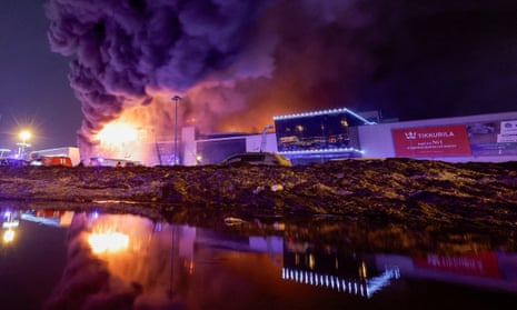 Smoke from fire rises above the burning Crocus City Hall concert venue following a shooting incident, outside Moscow, Russia.