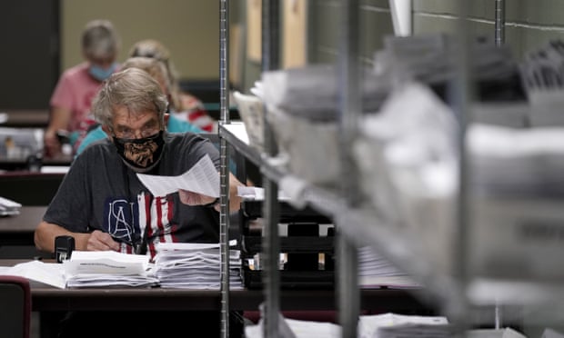 Election worker Kenneth Conkle processes mail-in ballot requests Tuesday in Olathe, Kansas.