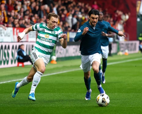 Johnny Koutroumbis of Motherwell (right) battles with and Alistair Johnston of Celtic.