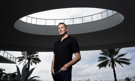 Scott Lyons, wearing black, palm trees in the background