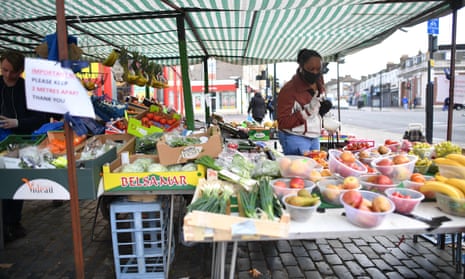 A fruit and veg stall with social-distancing signs in Newham, east London