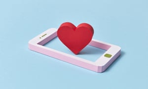 Papercraft smartphone with vertical standing red heart symbol handmade from colored paper on a pastel blue background