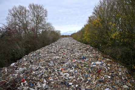 A large pile of fly-tipped waste is seen dumped in a field between the River Cherwell and the A34 near Kidlington, Oxfordshire.