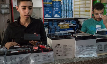 Staff in Imad Shlayl’s electronics shop in Gaza City test a battery storage system