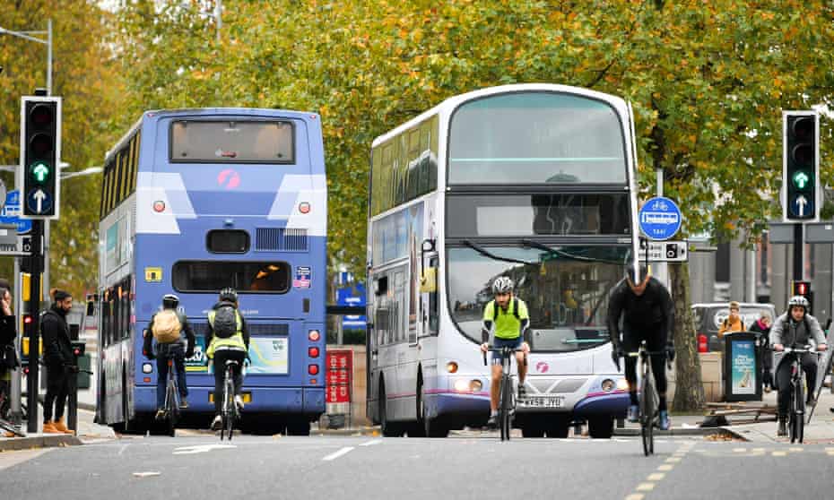 Cyclists and buses in Bristol city centre.